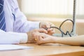 Doctor using sphygmomanometer checking blood pressure to a patient, doctor checking blood pressure Royalty Free Stock Photo