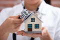 Doctor Using Stethoscope To Check Model House Royalty Free Stock Photo