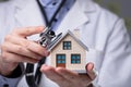 Doctor Using Stethoscope To Check Model House Royalty Free Stock Photo