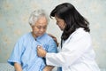 Doctor using stethoscope to checking the patient sit down on a bed in the hospital ward, healthy strong medical. Royalty Free Stock Photo