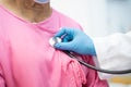 Doctor using stethoscope to checking the patient sit down on a bed in the hospital ward ; healthy strong medical concept Royalty Free Stock Photo