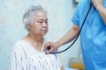 Doctor using stethoscope to checking the patient sit down on a bed in the hospital ward : healthy strong medical. Royalty Free Stock Photo