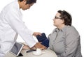 Doctor Using a Tablet in a Clinic with a Patient