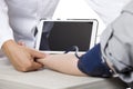 Doctor Using a Tablet in a Clinic with a Patient