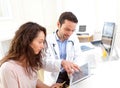 Doctor using tablet to inform patient Royalty Free Stock Photo
