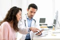 Doctor using tablet to inform patient Royalty Free Stock Photo