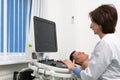 Doctor using ultrasound machine to scan heart of a male patient. Cardiologist makes a patient an echocardiographic test Royalty Free Stock Photo