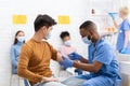 Doctor Vaccinating Asian Male Patient Giving Covid-19 Vaccine In Hospital Royalty Free Stock Photo