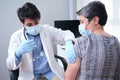 Doctor vaccinating mature woman patient in clinic Royalty Free Stock Photo