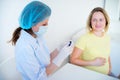 Doctor vaccinating a pregnant woman Royalty Free Stock Photo