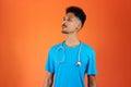Doctor or Veterinarian . Black Young Doctor Medical Resident With Stethoscope on Orange Background