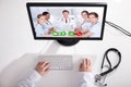 Doctor Video Conferencing With Medical Team On Computer Royalty Free Stock Photo