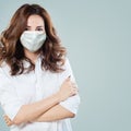 Doctor or virologist woman wearing safety face mask. Woman in medical mack. Flu epidemic and virus protection concept