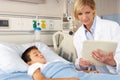 Doctor Visiting Child Patient On Ward Royalty Free Stock Photo