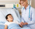 Doctor Visiting Child Patient On Ward Royalty Free Stock Photo