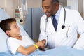 Doctor Visiting Child Patient On Ward Royalty Free Stock Photo