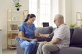 Physician visits senior male patient and measures his blood pressure with tonometer Royalty Free Stock Photo