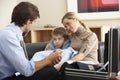 Doctor visiting sick child and mother at home