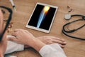 Doctor watching a digital tablet with x-ray of leg with pain in the internal knee Royalty Free Stock Photo