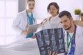 Doctor watching x-ray photography of elder woman