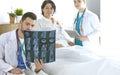 Doctor watching x-ray photography of elder woman