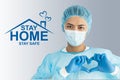 Doctor wear face mask, gloves, blue green uniform showing heart hands shape and stay home concepts Royalty Free Stock Photo