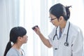 Doctor wear glasses checking a little girl patient eyes. Royalty Free Stock Photo