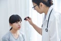 Doctor wear glasses checking a little girl patient eyes. Royalty Free Stock Photo