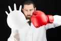 Doctor wearing boxing glove holding inflated glove.