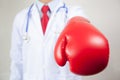 Doctor wearing boxing gloves in white background Royalty Free Stock Photo