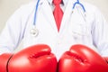 Doctor wearing boxing gloves in white background Royalty Free Stock Photo