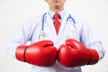 Doctor wearing boxing gloves in white background Royalty Free Stock Photo