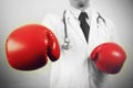 Doctor wearing boxing gloves in white background Royalty Free Stock Photo