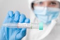 Doctor wearing disposable coverall or protective PPE suit with mask and safety google holding a test tube with empty Royalty Free Stock Photo