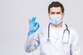 Doctor Wearing Gloves and Medical Mask. Medical Concept Corona Virus. Ok sign