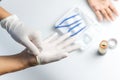 Doctor wearing gloves to clean the wound on the boy`s palm