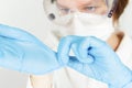 A doctor wearing a mask and goggles removes medical gloves Royalty Free Stock Photo
