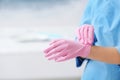 Doctor wearing medical gloves on color background. Royalty Free Stock Photo