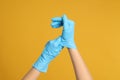 Doctor wearing medical gloves on background, closeup Royalty Free Stock Photo