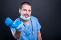 Doctor wearing scrubs handing telephone receiver and smiling Royalty Free Stock Photo