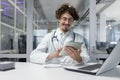 Doctor in White Lab Coat Uses Tablet in Medical Office Royalty Free Stock Photo