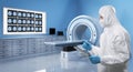 Doctor wears medical protective suit or coverall suit with x-ray brain and mri scan machine Royalty Free Stock Photo