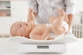 Doctor weighting baby on scales Royalty Free Stock Photo