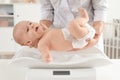 Doctor weighting baby on scales