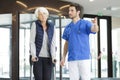 Doctor welcoming senior female patient in hospital