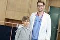 Doctor welcoming young boy in clinic