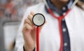 Doctor in white coat shows stethoscope membrane