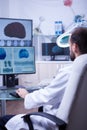 Doctor in white coat sitting at his desk in the hospital typing on his computer Royalty Free Stock Photo