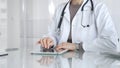 Doctor using digital tablet for remote medical consultation, providing modern healthcare services, telehealth concept Royalty Free Stock Photo
