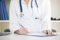 Doctor in a white labcoat writing Royalty Free Stock Photo